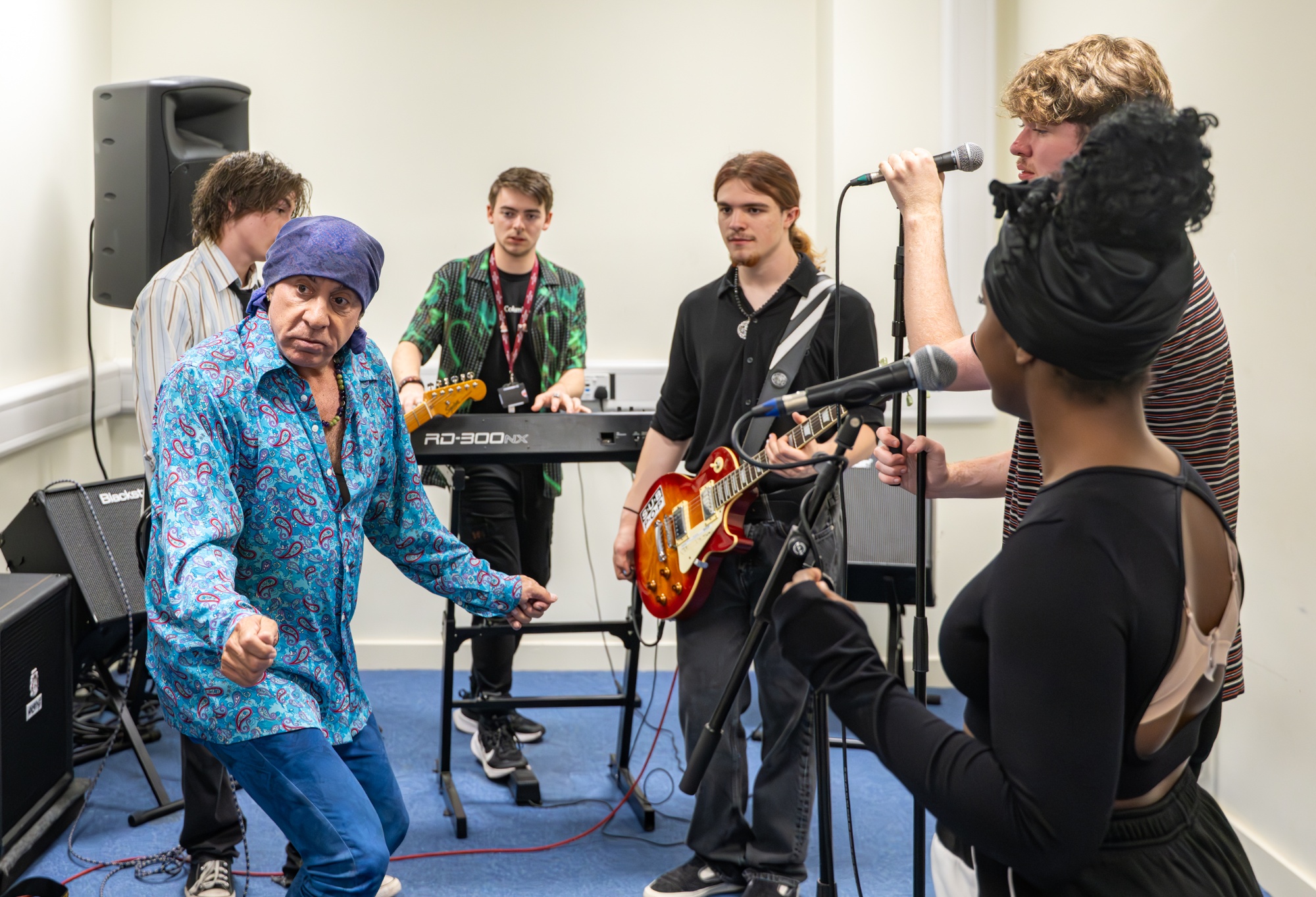 Steve Van Zandt guides the students in the practice room as they rehearse as a band.
