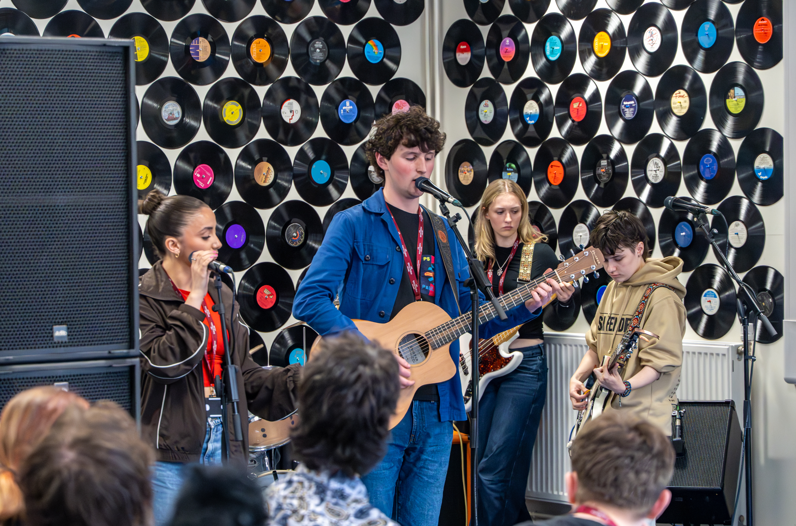 Four students play perform in front of their peers and Steve Van Zandt.