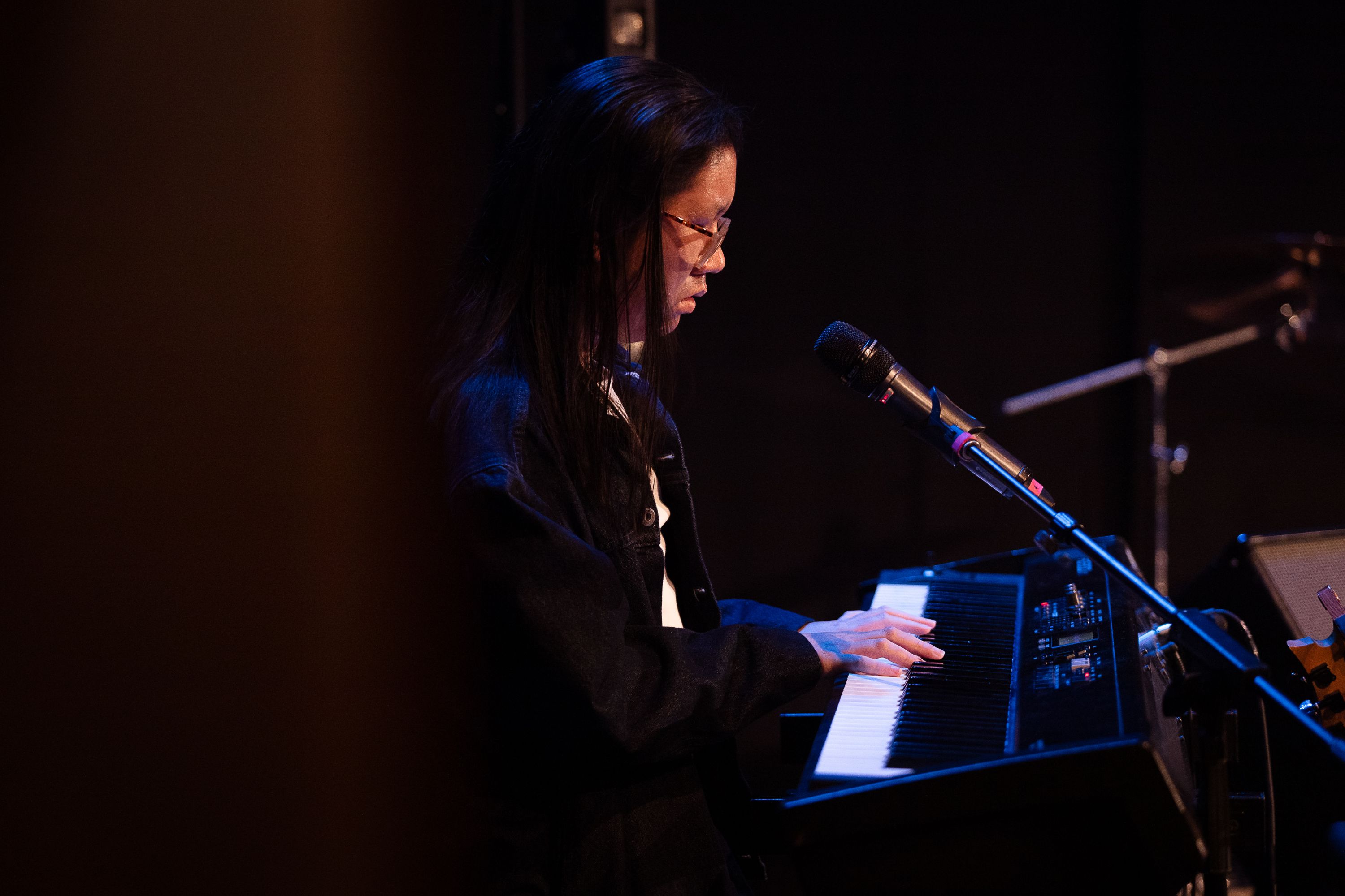 A student playing the keyboard on a solo performance.